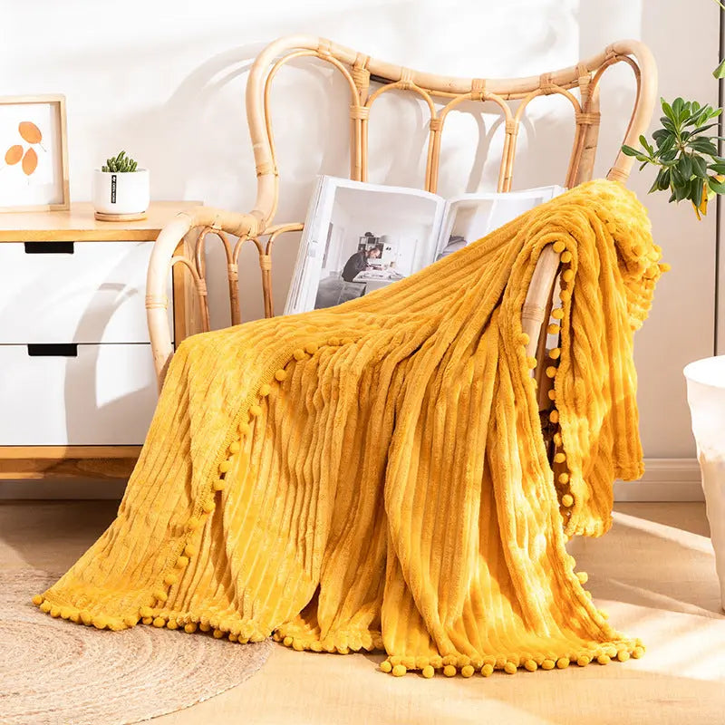 Pom detail throw with striped velvet texture ideal for lounging and home comfort