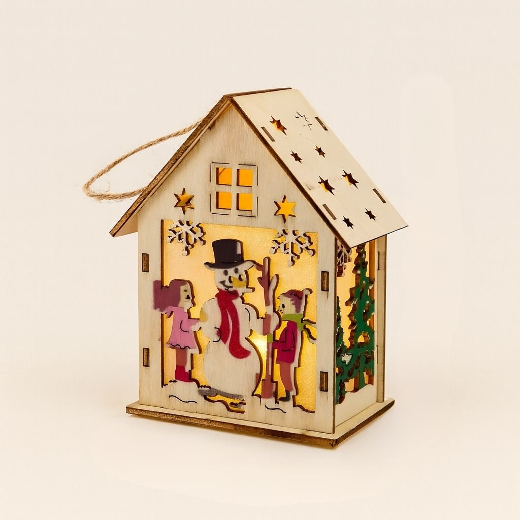 Decorative wooden house-shaped lantern with a snowman design, surrounded by green gift boxes.