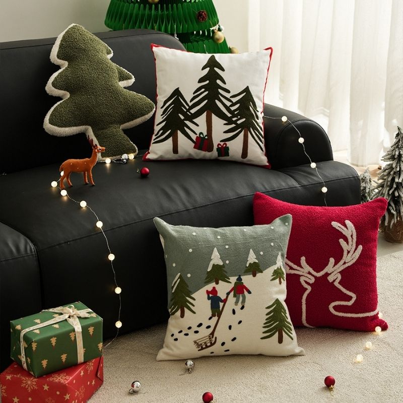 Holiday pillow case featuring embroidered present motifs and festive snowflake details