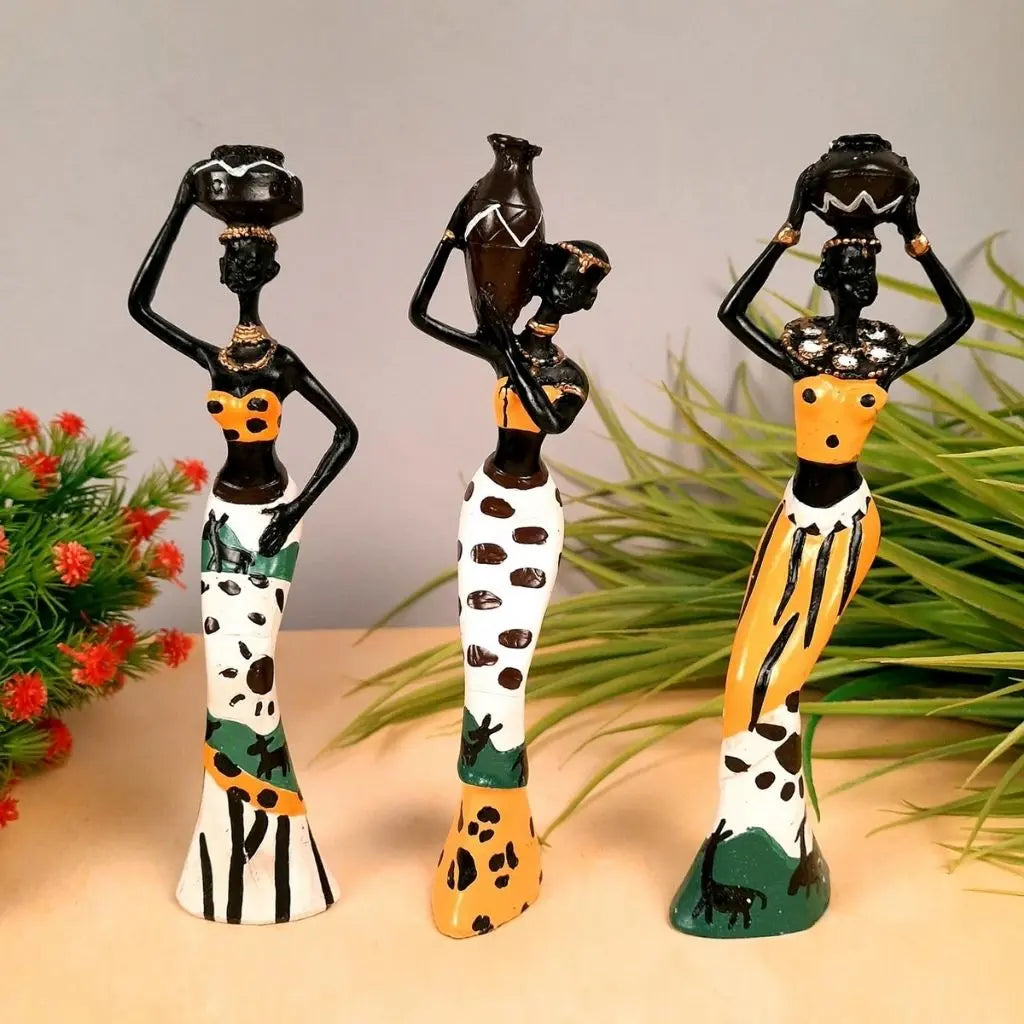 Traditional African decorative sculptures with detailed patterned clothing and vessel accessories for home display