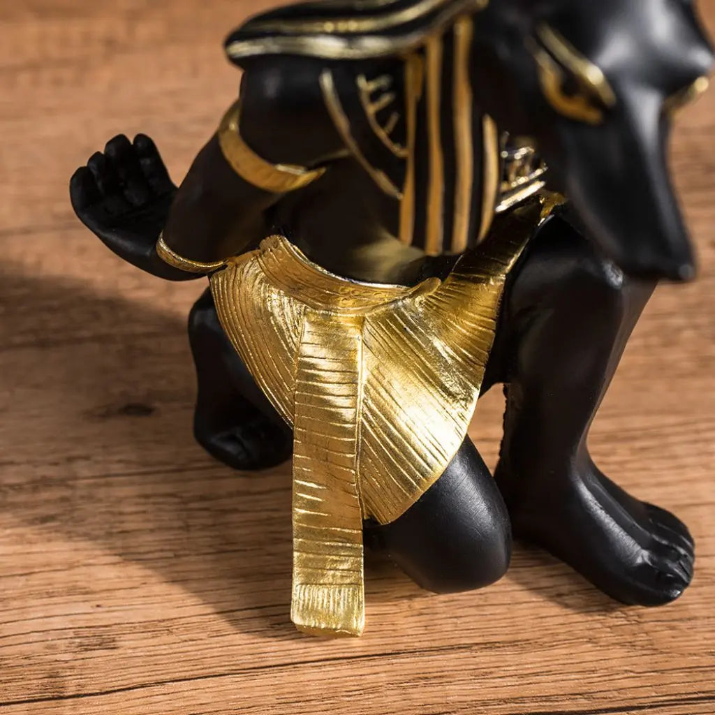 Egyptian wine bottle holder featuring Anubis crouching figure design for elegant wine display and storage