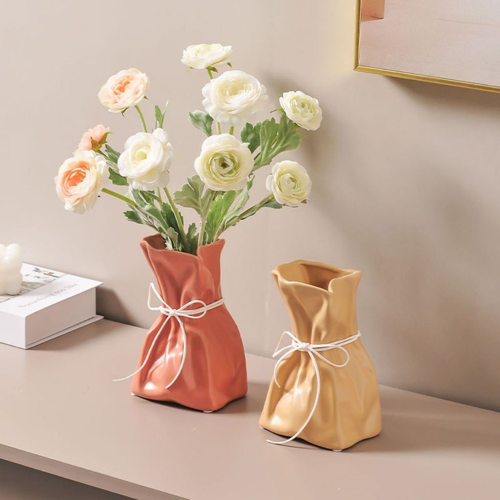 Artisan crafted ceramic flower holder with rope drawstring detail for elegant home accents
