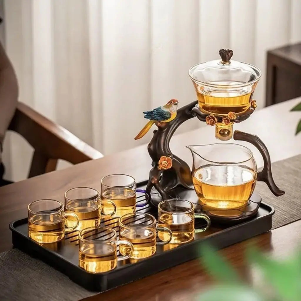 Tea set with glass teapot and cups on a wooden tray