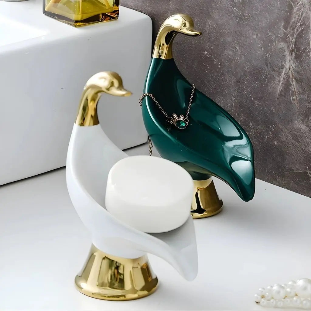 Bathroom soap dish in ceramic swan shape with glossy white finish for organized vanity storage