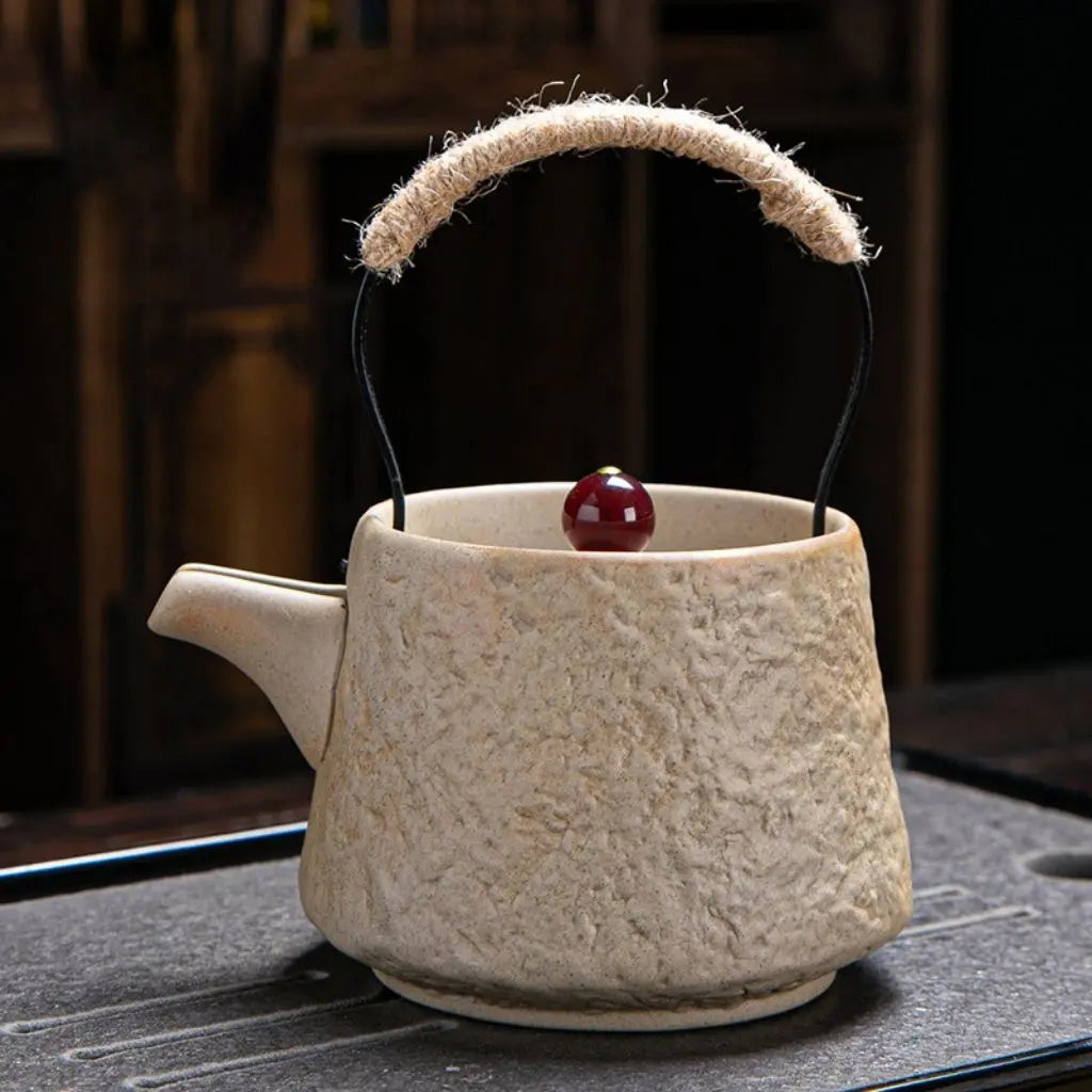 Japanese-inspired ceramic teapot with rope-wrapped lifting handle perfect for traditional tea ceremony rituals