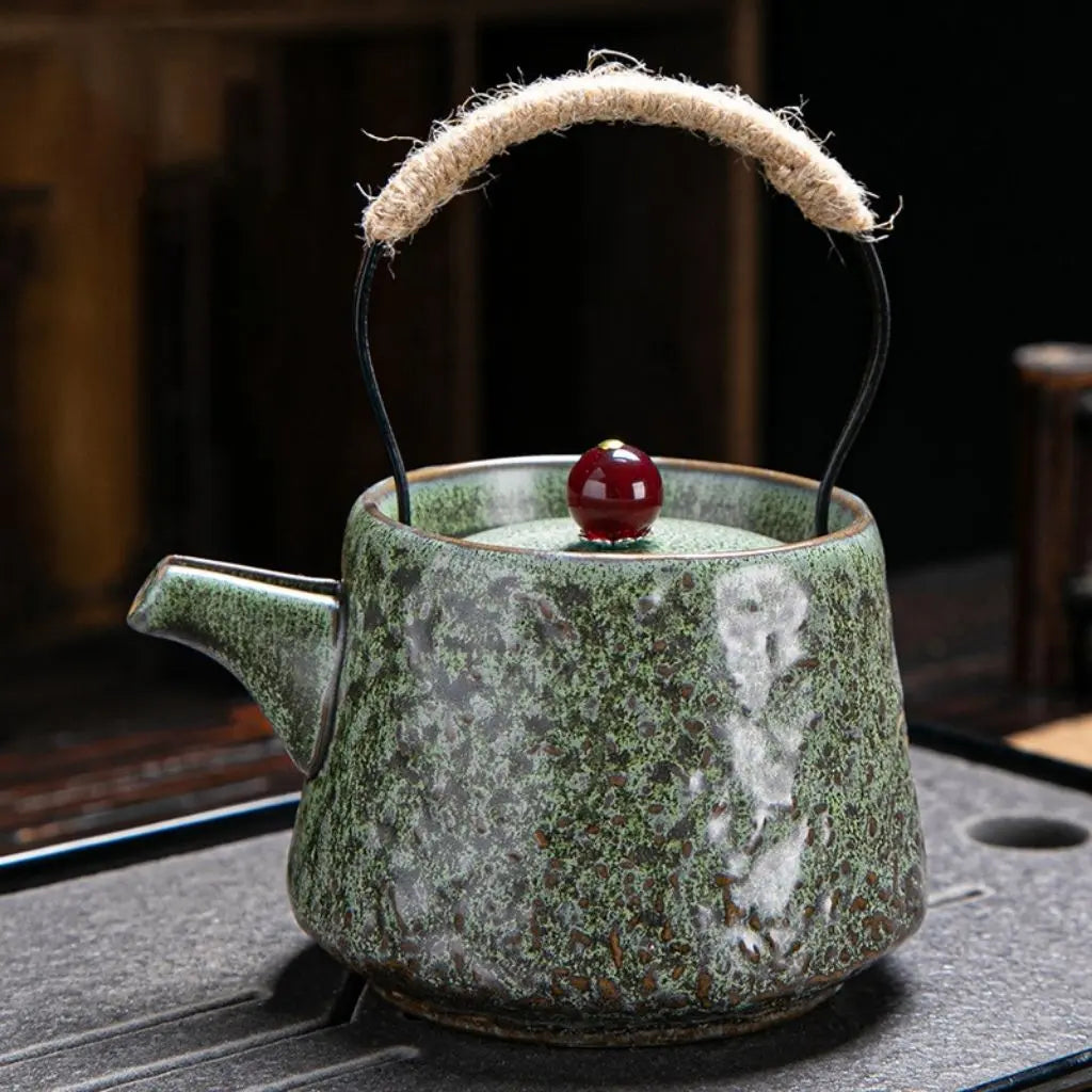 Artisan ceramic teapot featuring coarse pottery texture and distinctive beam handle design for tea enthusiasts