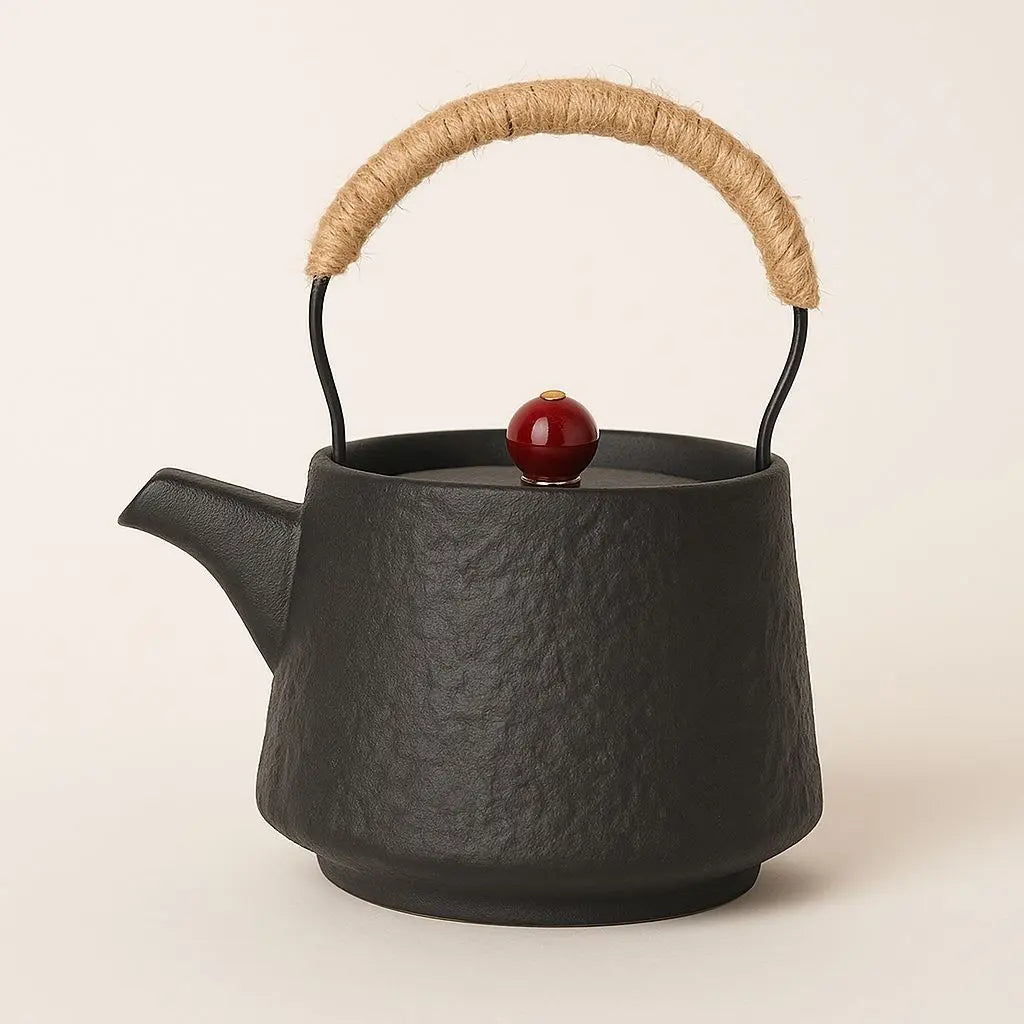 Handcrafted ceramic teapot with rope-wrapped beam handle and red lid accent for authentic gongfu tea brewing