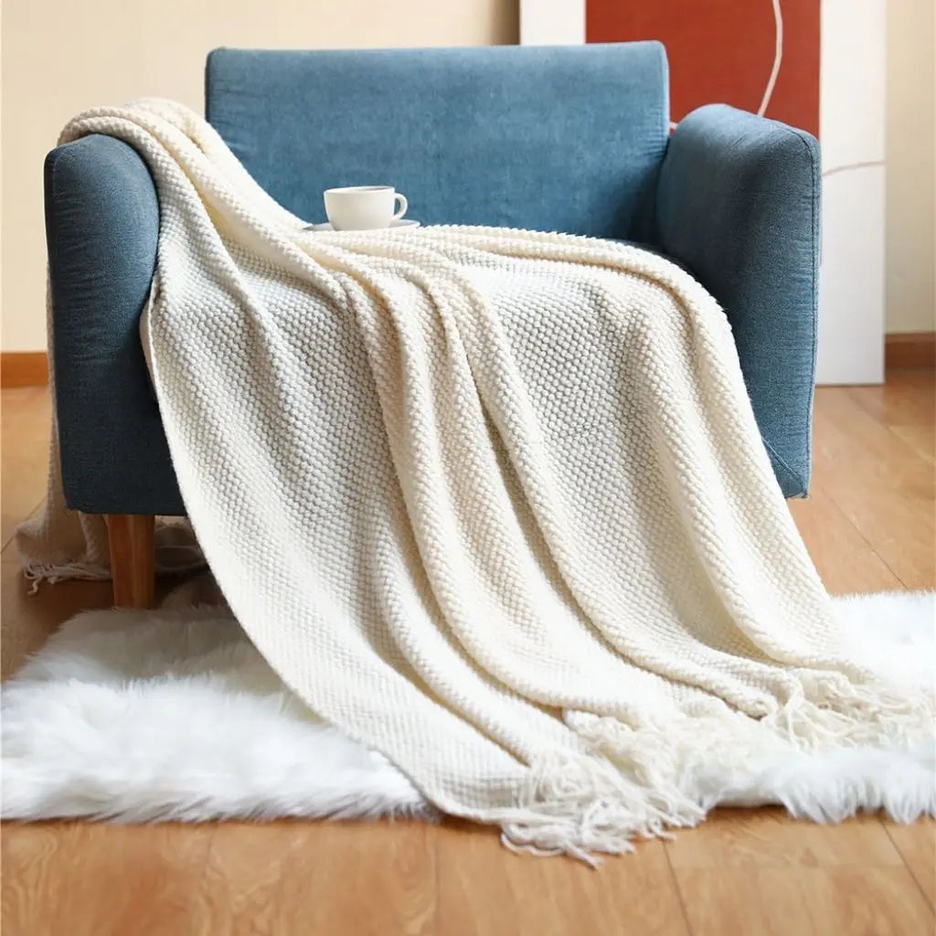 Woven throw blanket with textured acrylic knit and fringe detail for living room décor