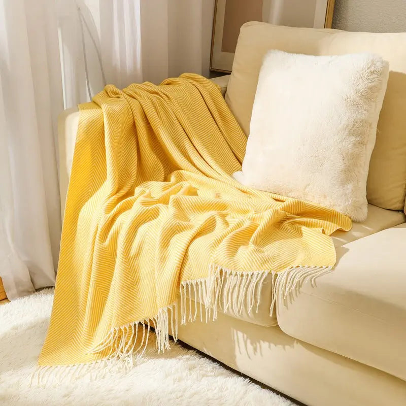 Herringbone throw blanket with fringe edges for reading nooks and couch covering
