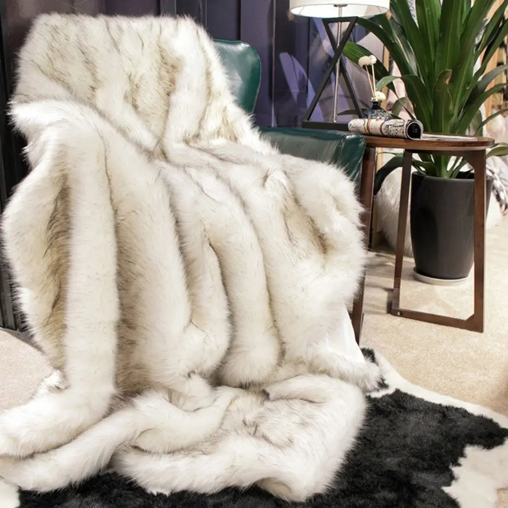 Textured faux fur throw blanket with smooth plush surface for warmth