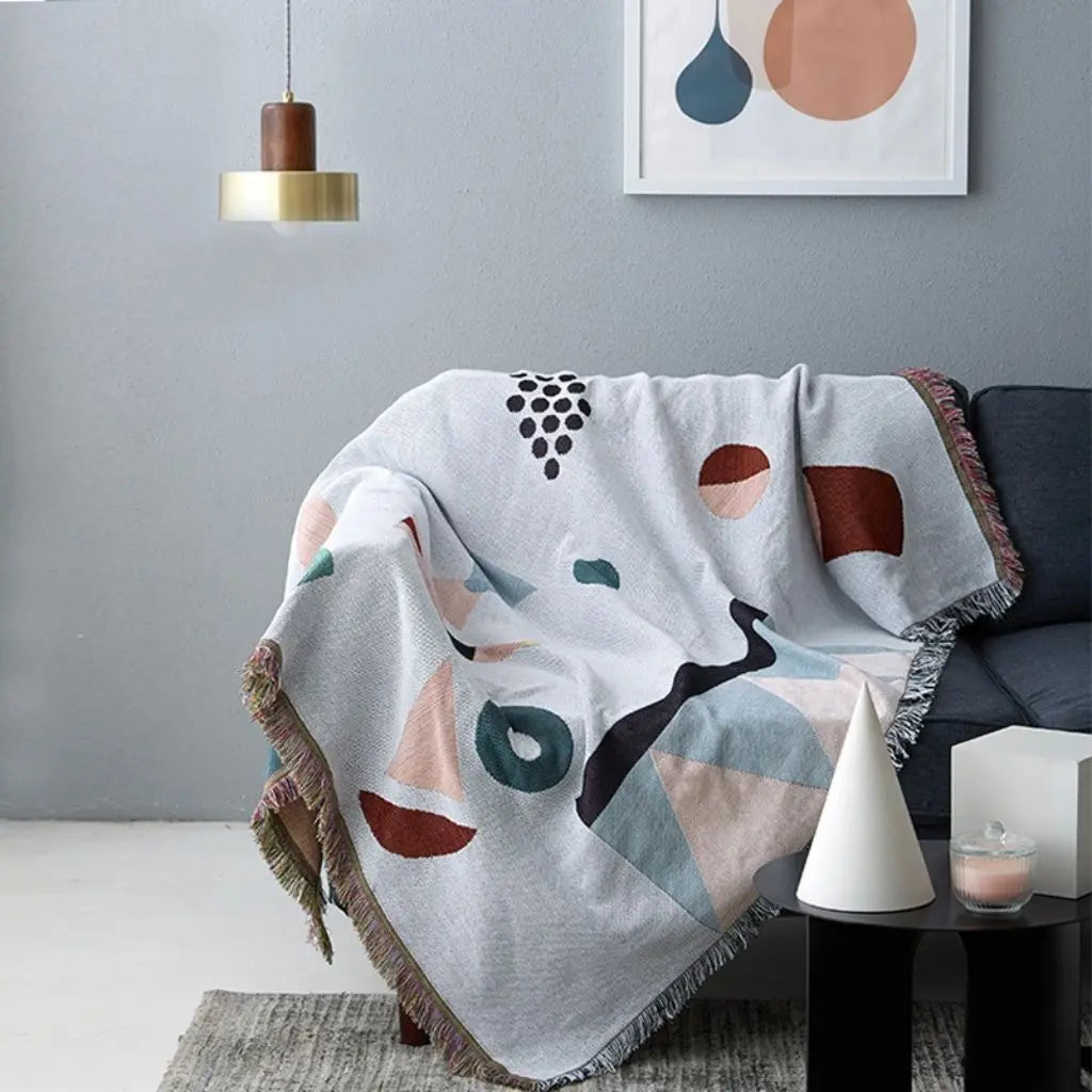 Geometric sofa throw in cotton polyester blend with bold decorative pattern