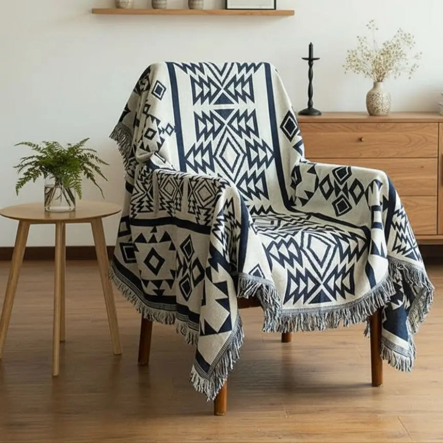 Cotton throw blanket with geometric woven pattern and fringed edges for home décor