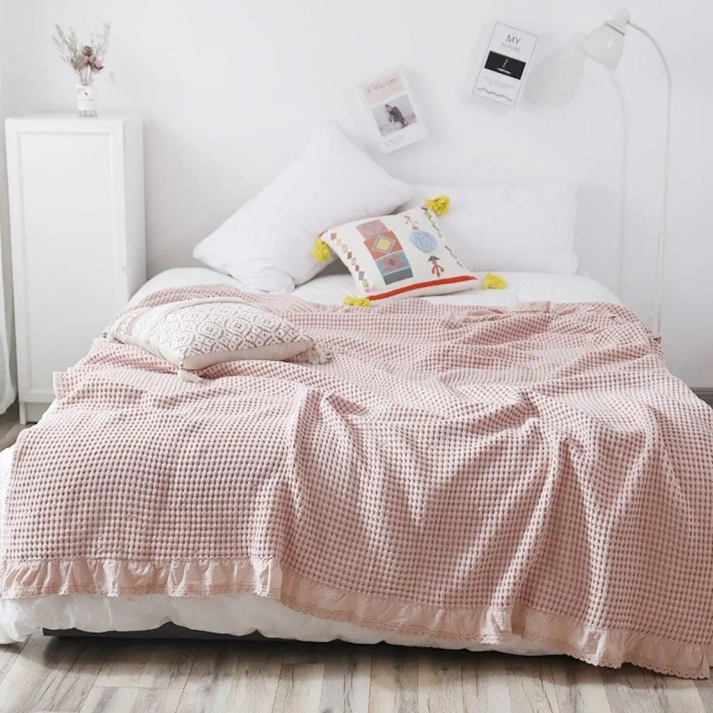 Lightweight waffle weave quilt with delicate lace edge detail for home decor