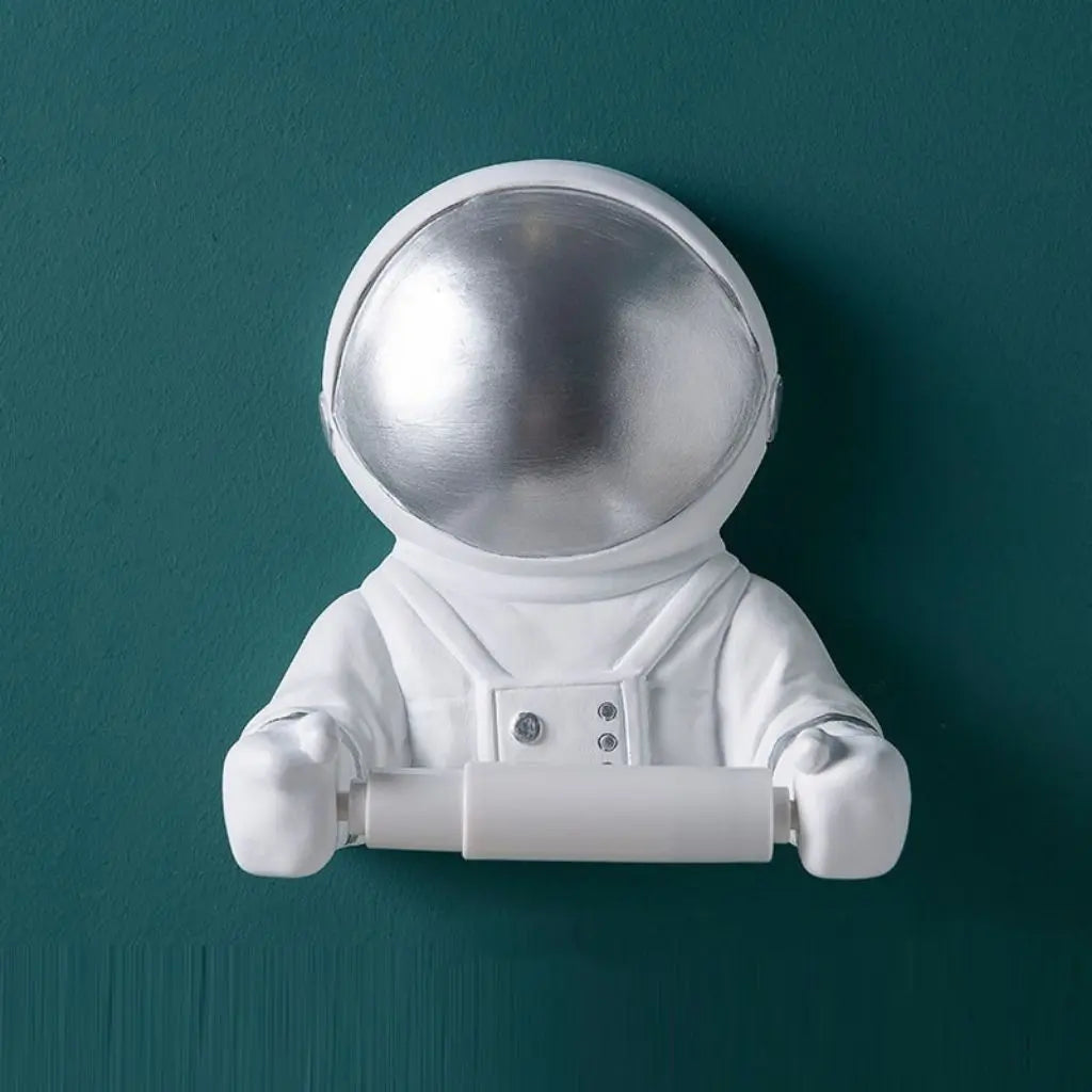 Wall mounted astronaut toilet paper holder with metallic visor. Resin space-themed bathroom tissue holder adds fun decor to modern bathrooms.