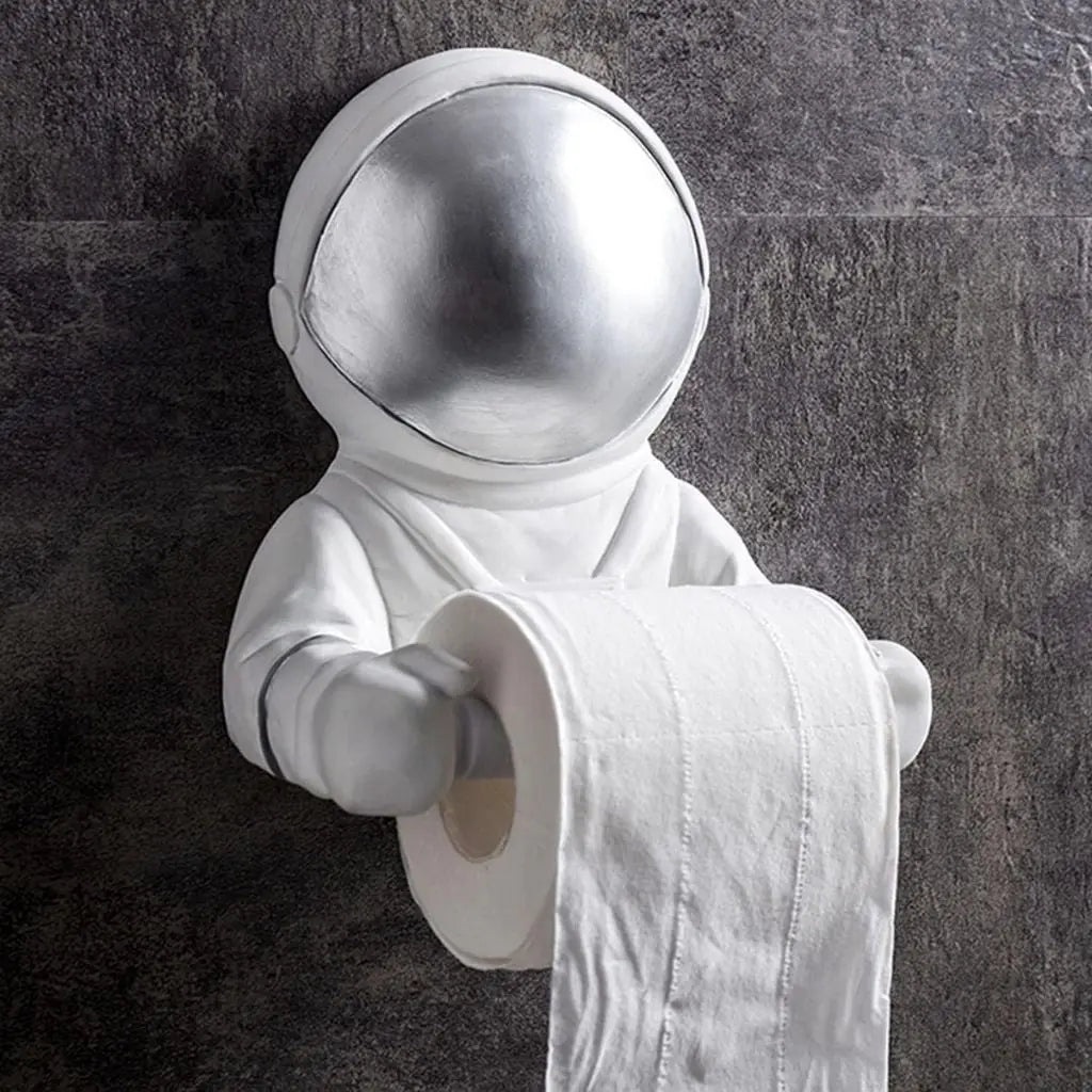 Wall mounted astronaut toilet paper holder with metallic visor. Resin space-themed bathroom tissue holder adds fun decor to modern bathrooms.