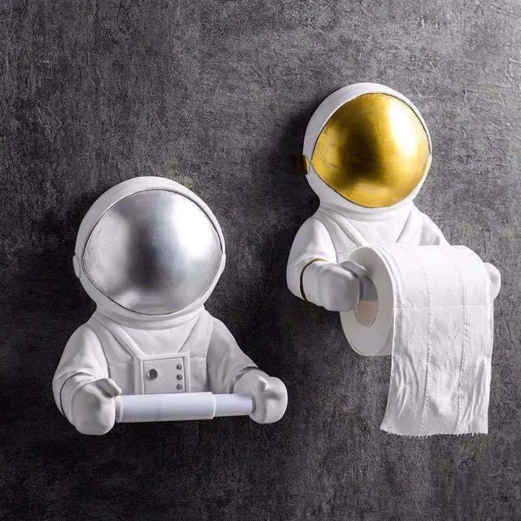 Two astronaut-themed toilet paper holders on a gray wall.