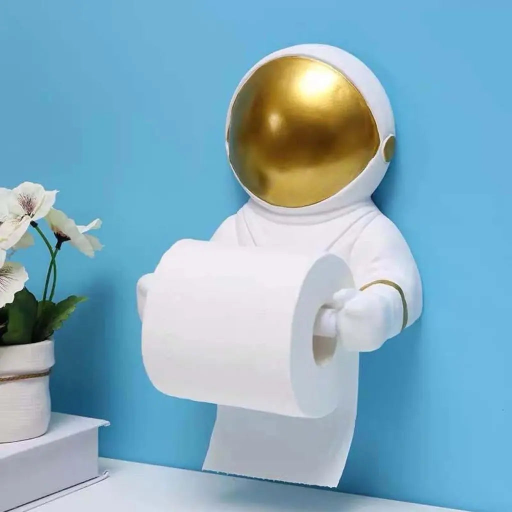 Astronaut-shaped toilet paper holder with a gold helmet on a blue background