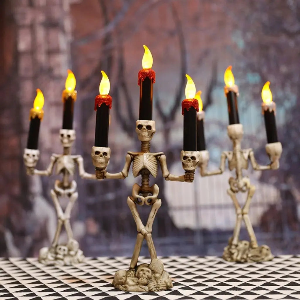Detailed skull and bone candle holder featuring three flickering LED flames for spooky atmosphere