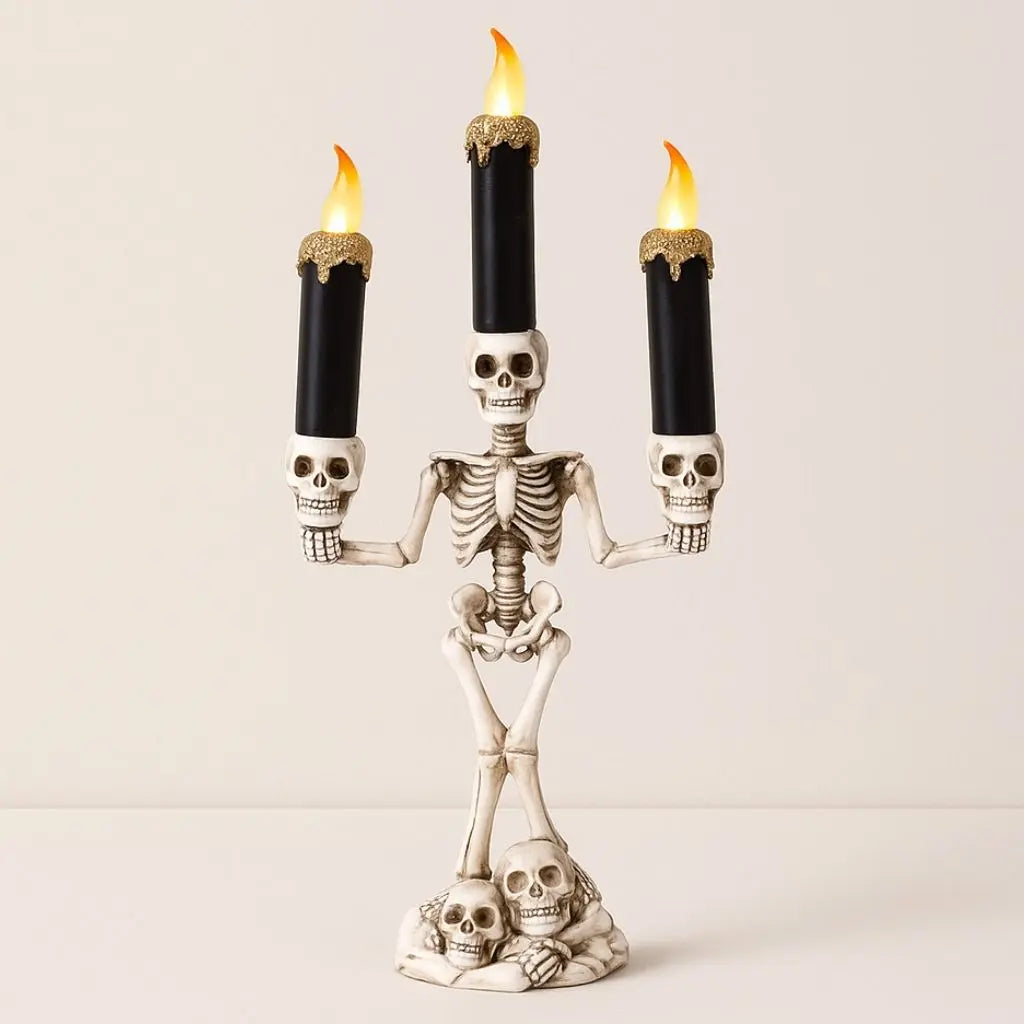 Skeleton candelabra with three LED candles on a white background