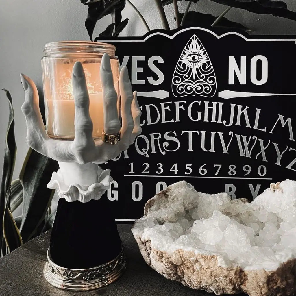 Handcrafted witch candle stand made from detailed resin, atmospheric Halloween art for gothic home styling