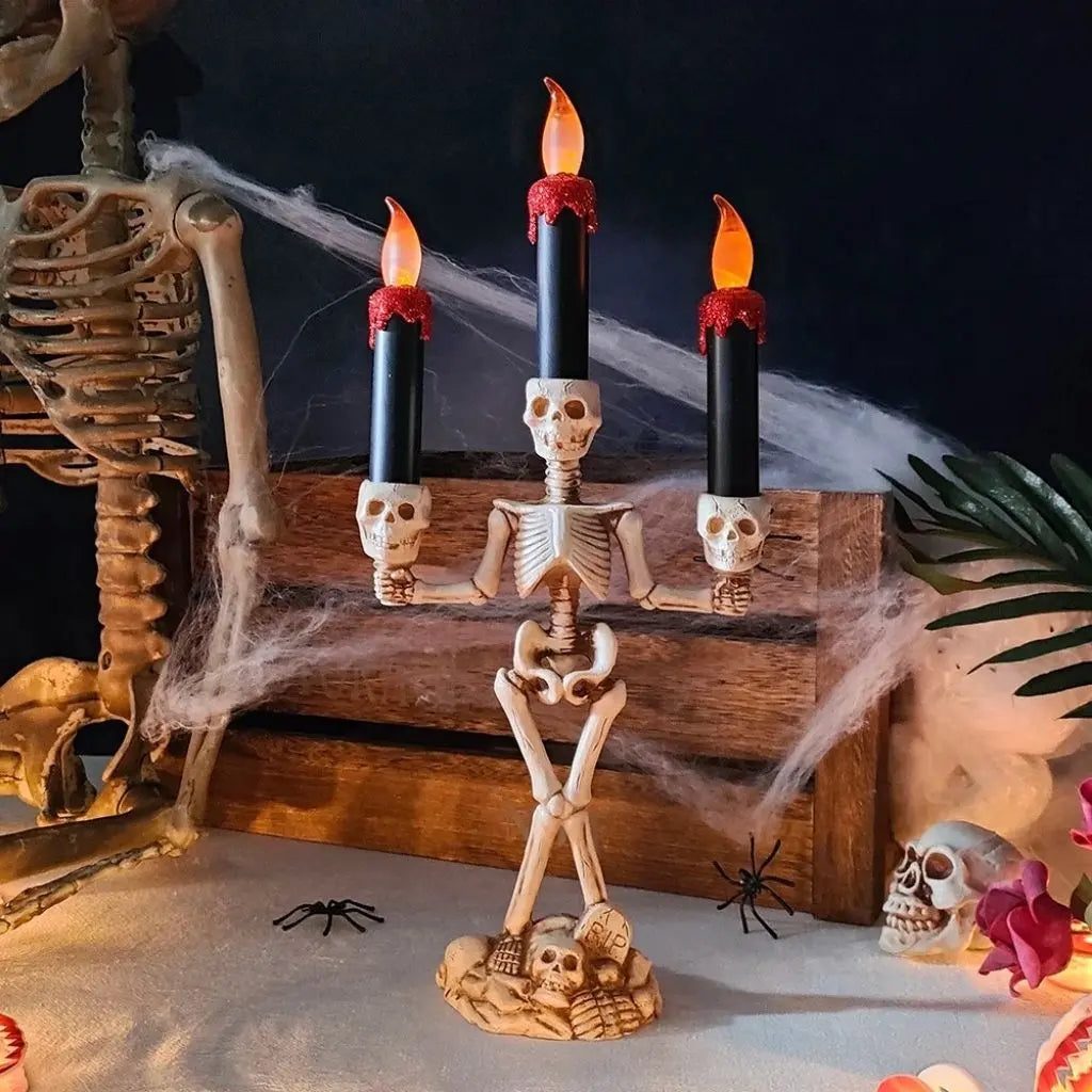 Gothic skeleton holding LED candles with realistic bone detailing for haunted house decorations