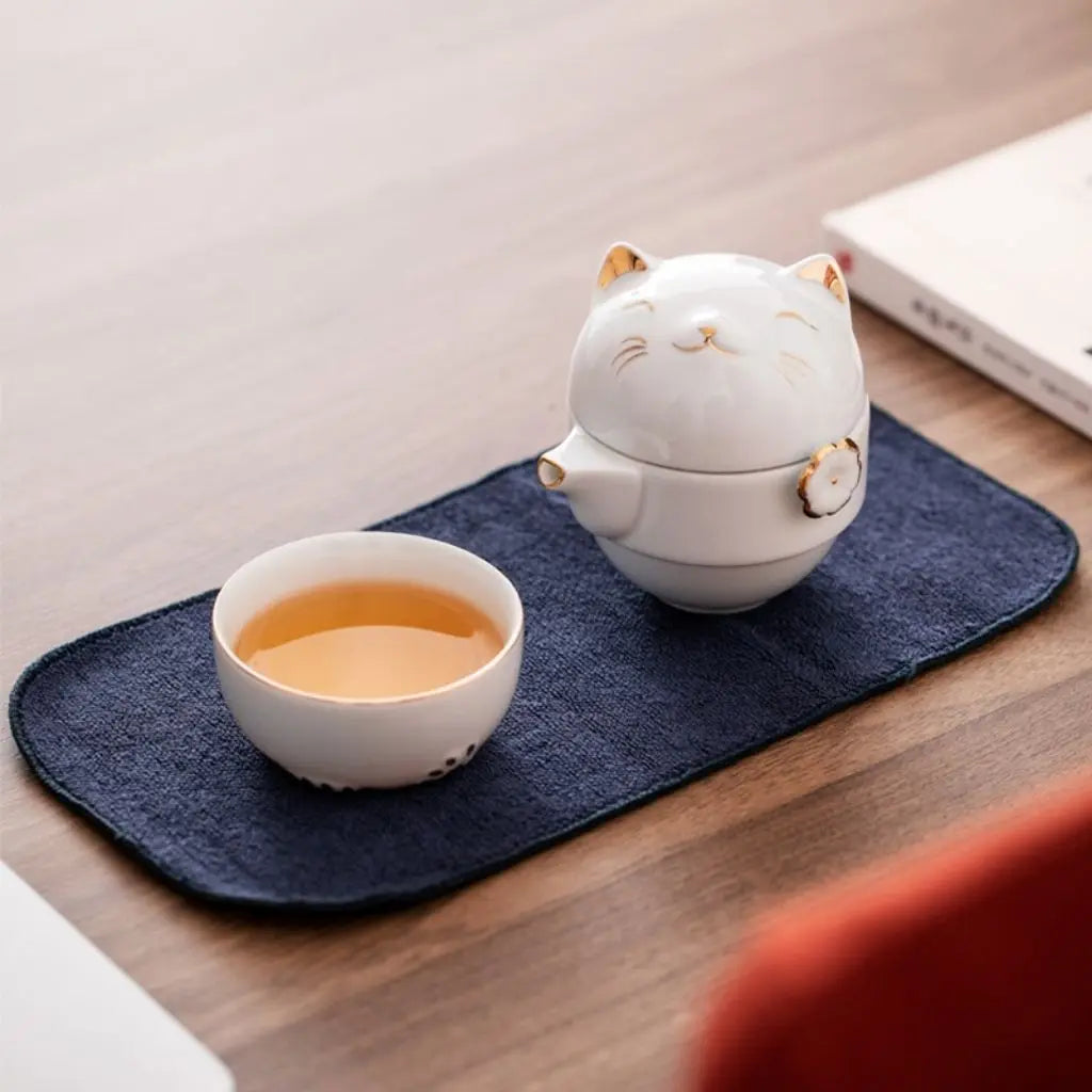 Fortune cat ceramic teapot detail showing premium porcelain craftsmanship for travel tea enthusiasts