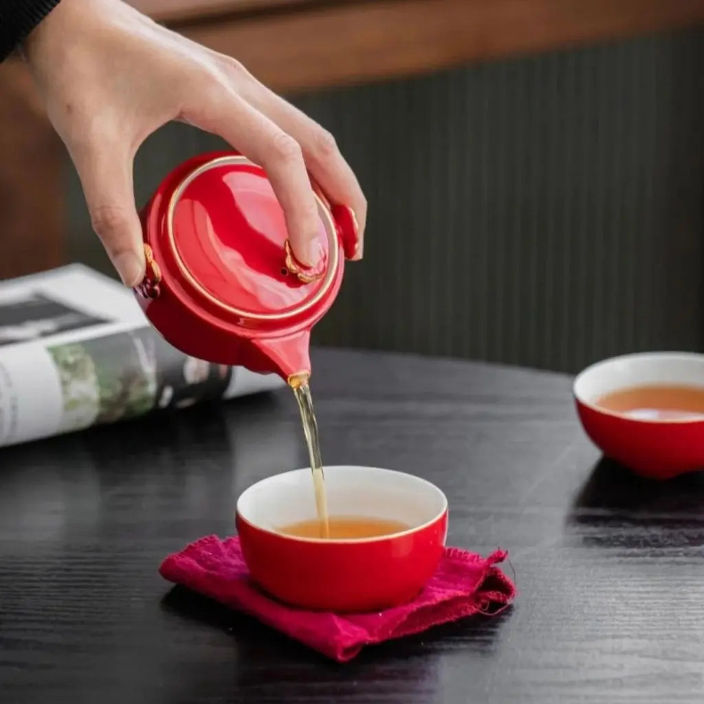 Travel tea set storage case with ceramic fortune cat teapot and cups organized for portability