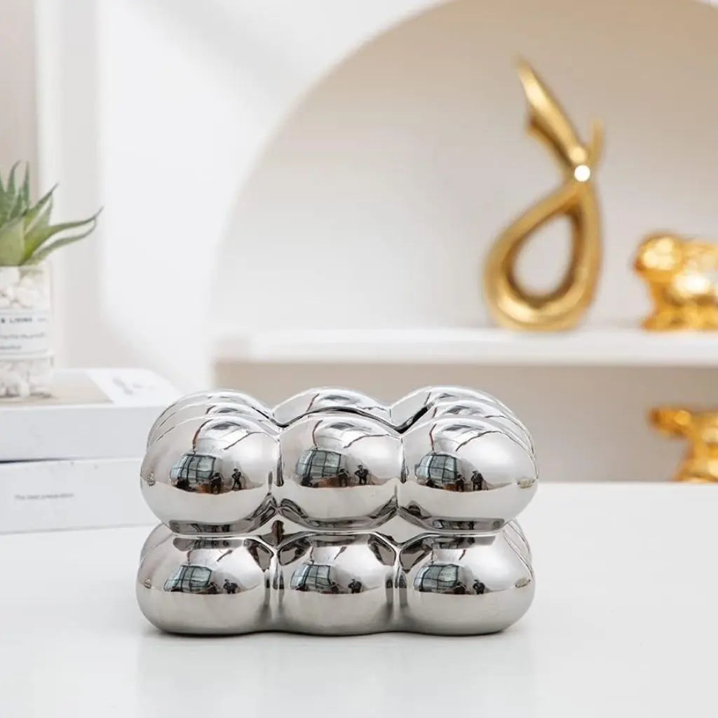 Polished ceramic tissue holder with decorative bubble accent, available in multiple color options