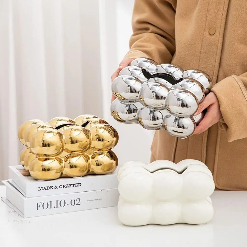 Compact ceramic tissue dispenser fits standard tissue packs, perfect for coffee tables