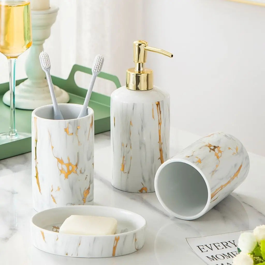 Marble-patterned bathroom set with toothbrushes, soap dish, and dispenser on a light surface.