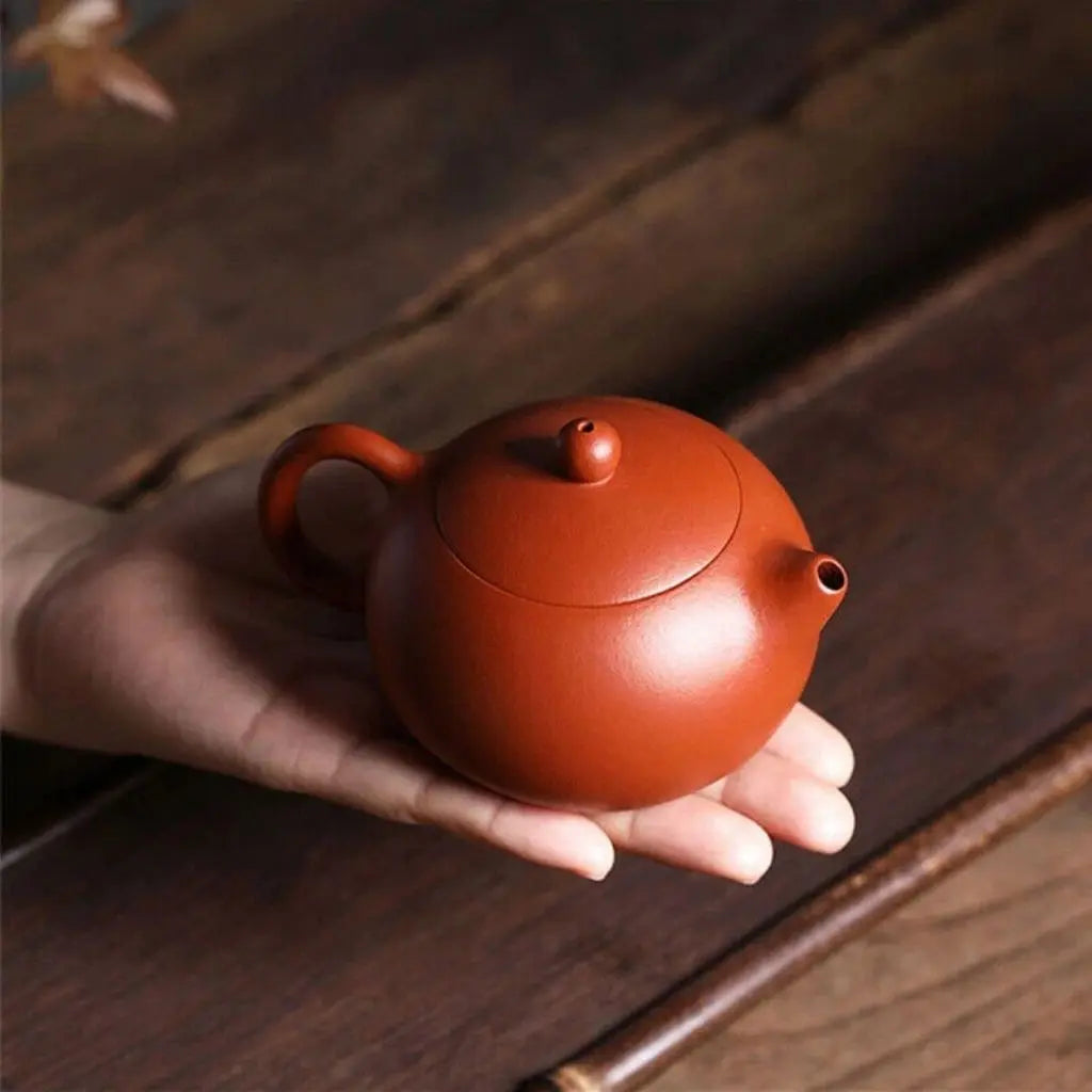 Traditional red clay ceramic teapot with classic design elements, crafted for authentic kung fu tea brewing