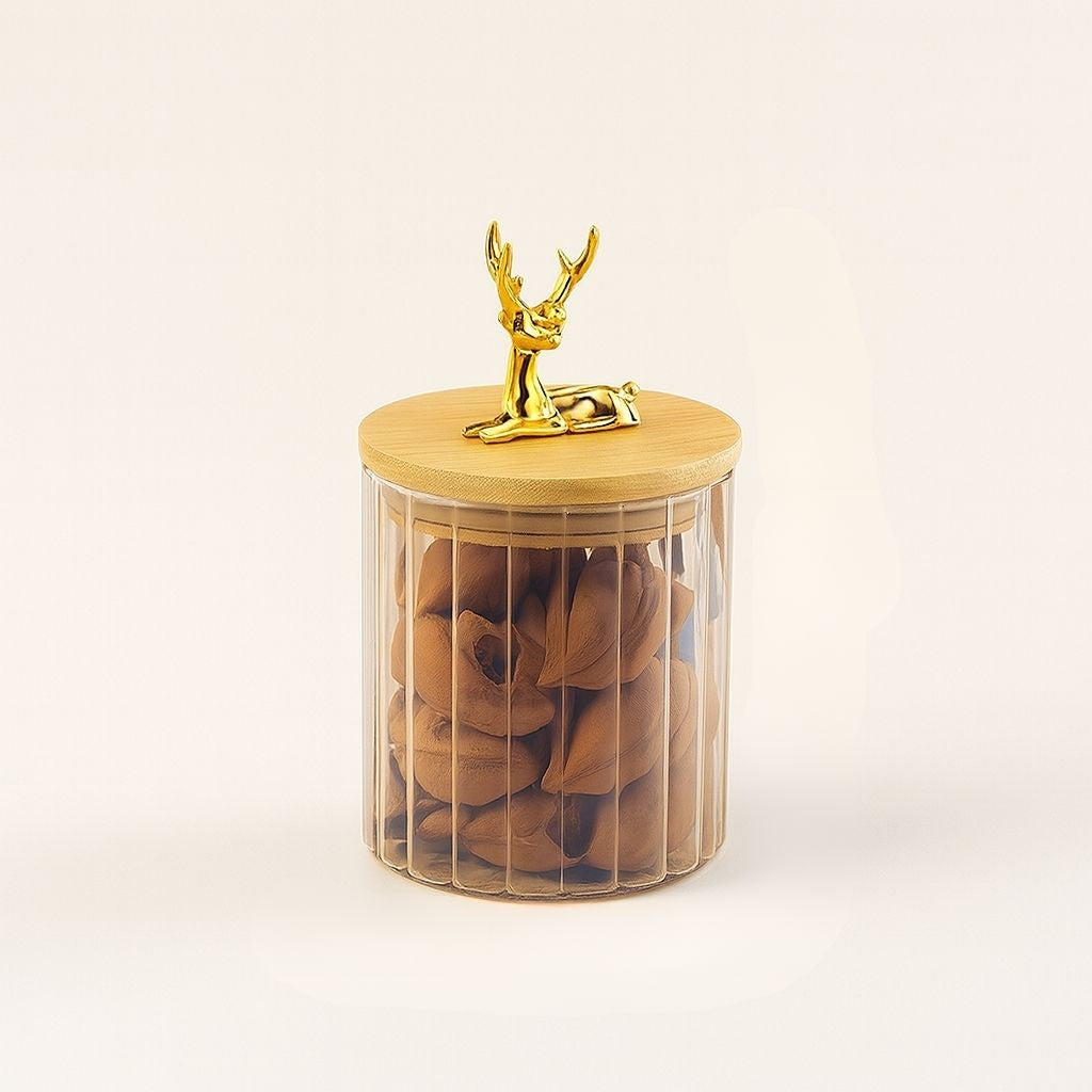 Amber glass jar with vertical stripes and elk figurine lid