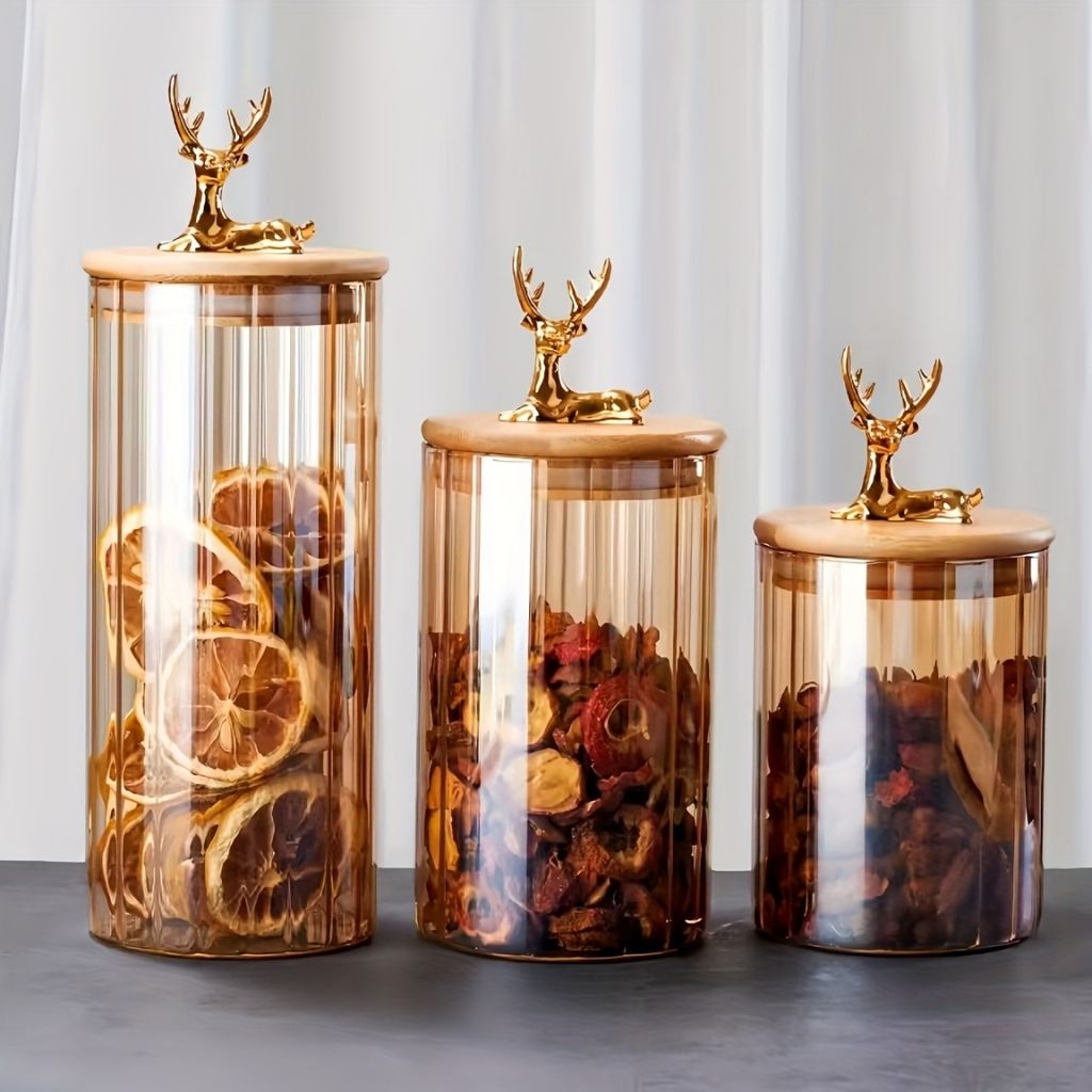 Decorative glass jar with vertical ribbing and elk shaped lid handle