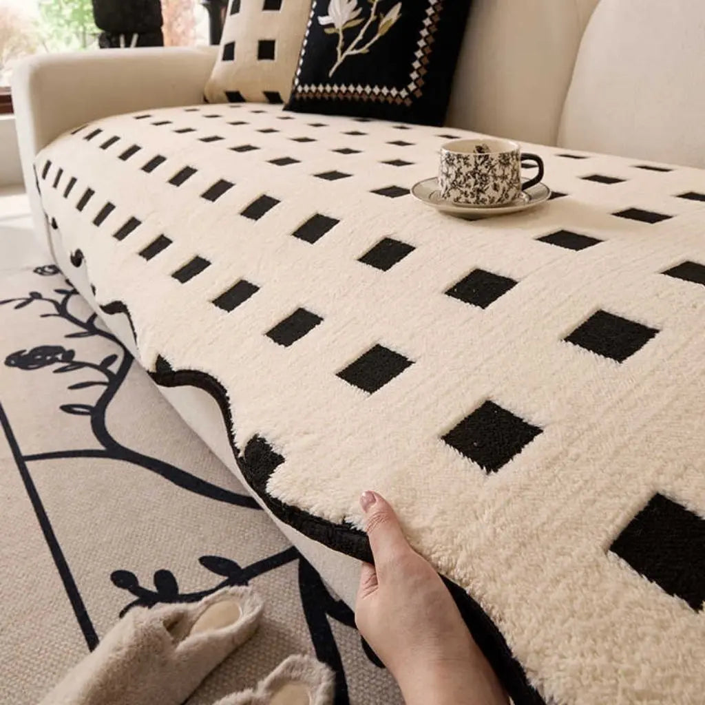 Soft plush fabric texture of geometric sofa cover showing cozy material for furniture protection