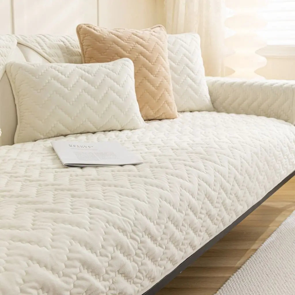 Crystal velvet quilted furniture cover providing complete sofa protection and comfort enhancement