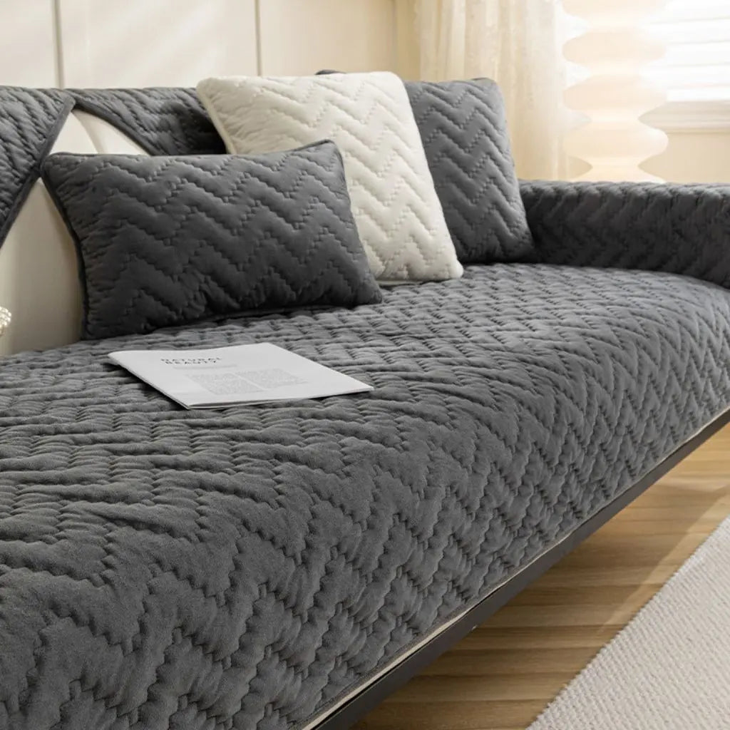 Velvet quilted sofa protector showing comprehensive furniture coverage and protection features