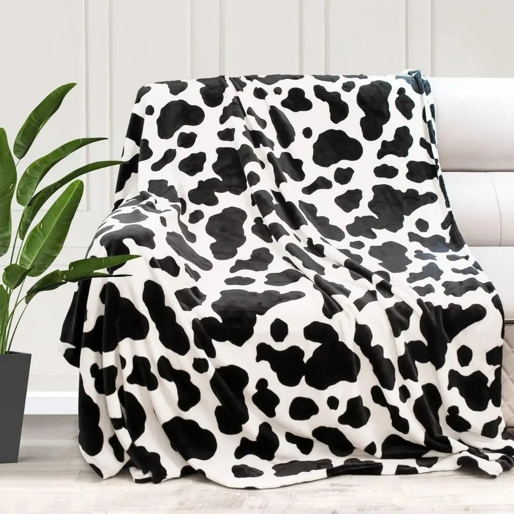 Close-up of smooth lightweight flannel fabric showing detailed black white cow print pattern texture