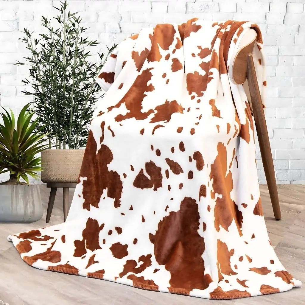 Cow print flannel blanket available in multiple sizes from 27x39in to 59x79in for beds and sofas