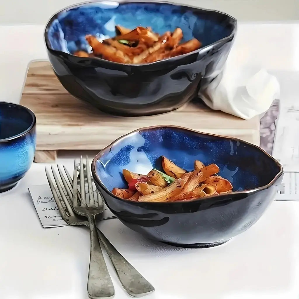 Deep ceramic bowl with modern irregular silhouette, crafted for versatile serving and dining needs