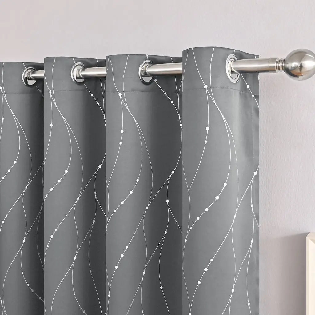 Gray blackout curtains with textured wave pattern, offering superior light blocking for bedrooms and offices