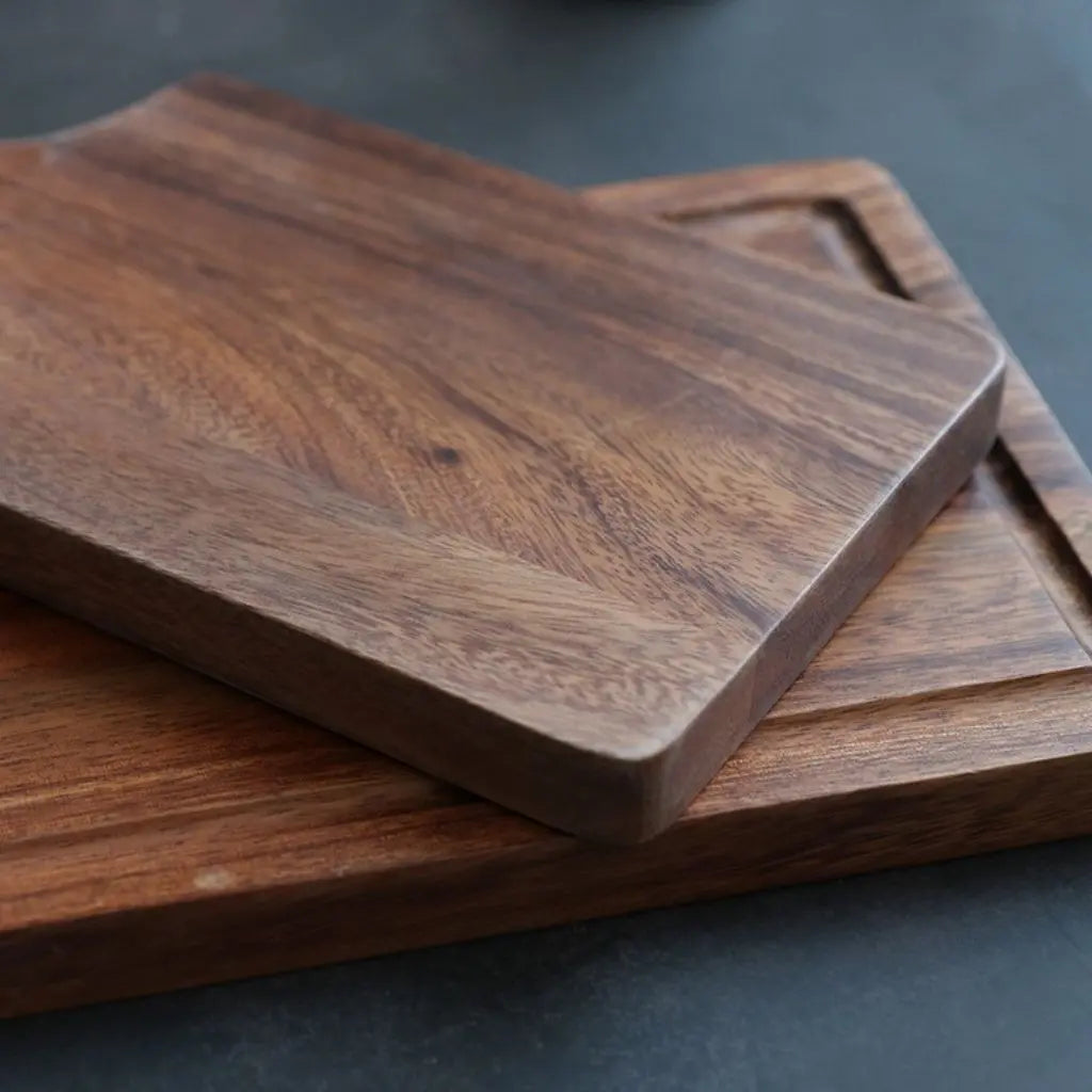 Solid wood kitchen cutting board with leather hanging loop and natural finish for food prep tasks