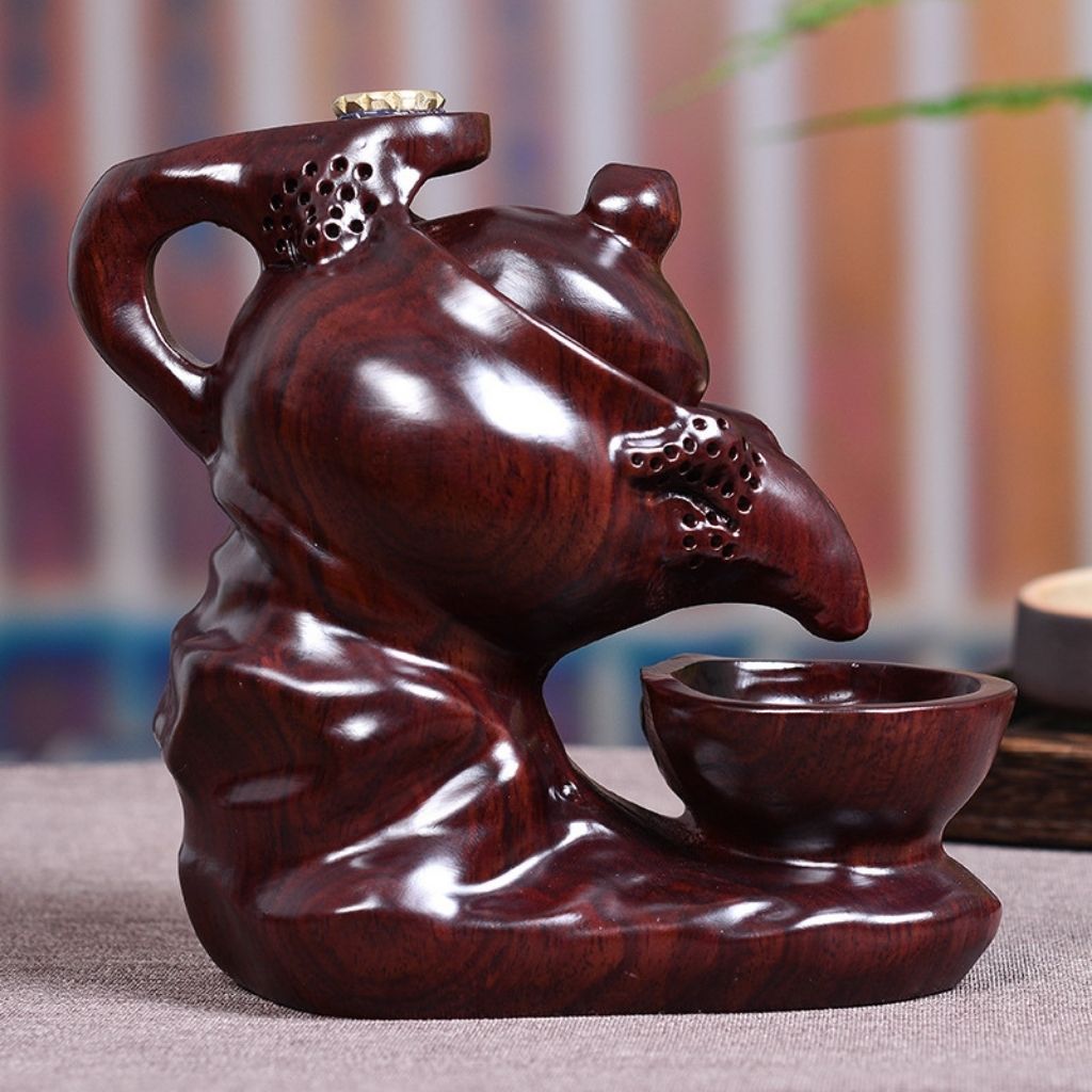 Hand carved ebony wood incense holder with traditional teapot form and dark finish