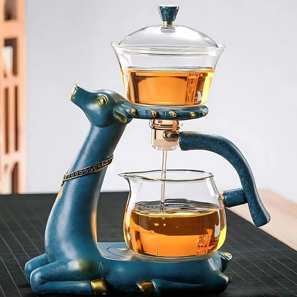 Blue deer-shaped tea press with glass container on a wooden surface