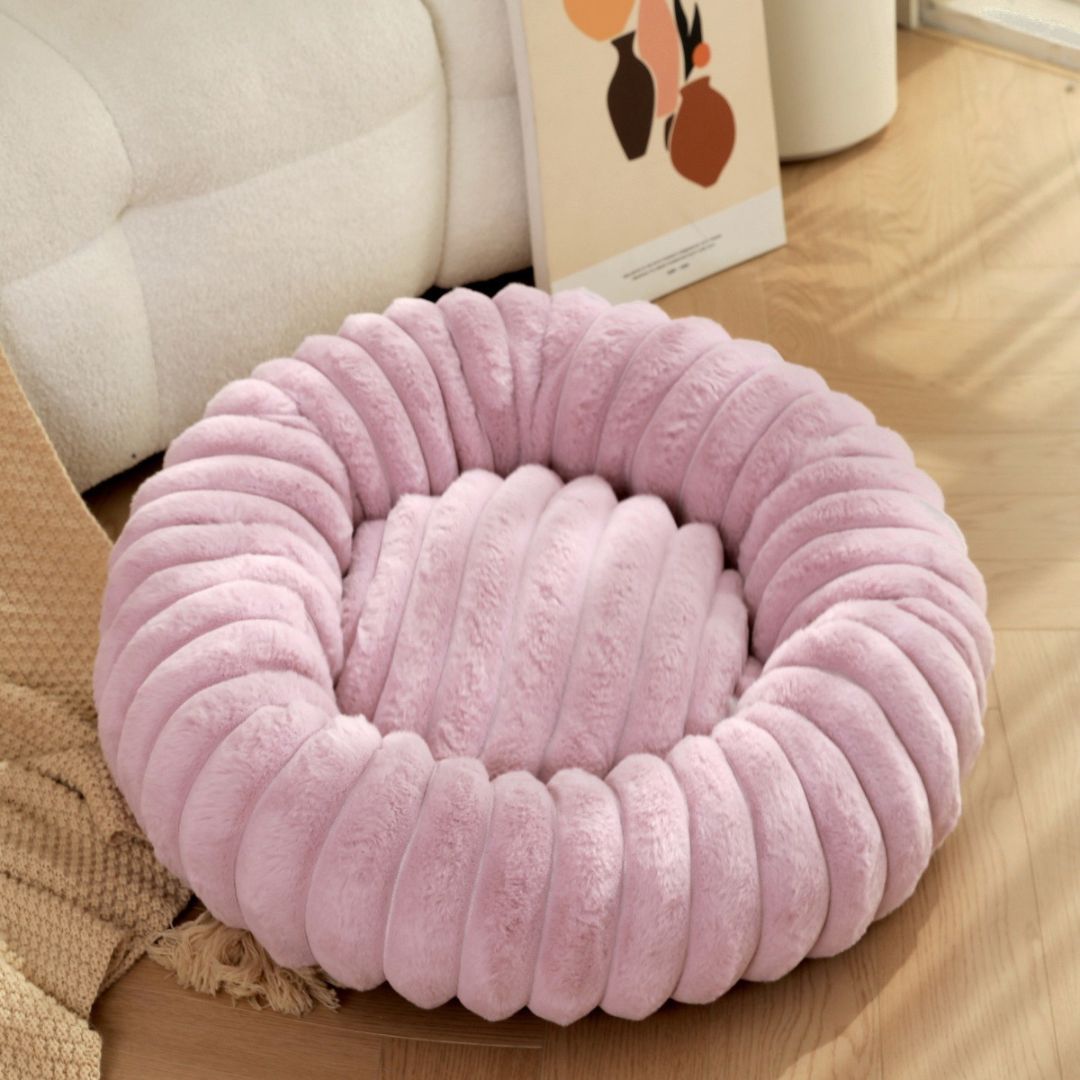 Round plush dog bed with raised edges for small to large dogs in soft rabbit fur material