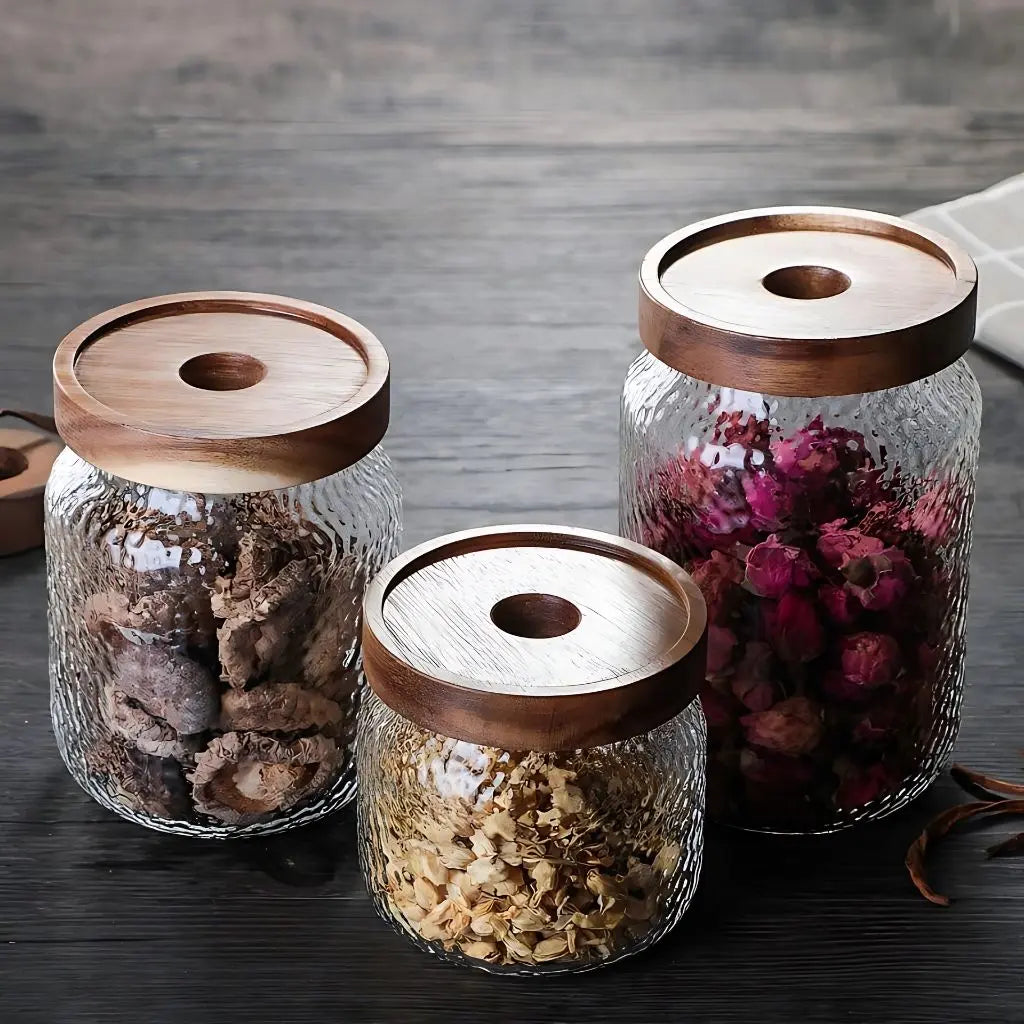 Glass storage container with natural wood lid combining functionality and stylish kitchen countertop decor