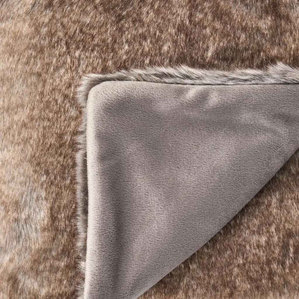 Close-up of faux fur blanket showcasing soft textured material with breathable construction for year-round comfort