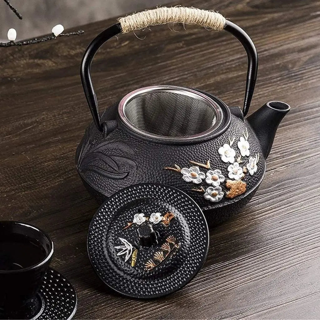 Traditional cast iron teapot featuring rope-wrapped handle and floral motifs for comfortable tea pouring