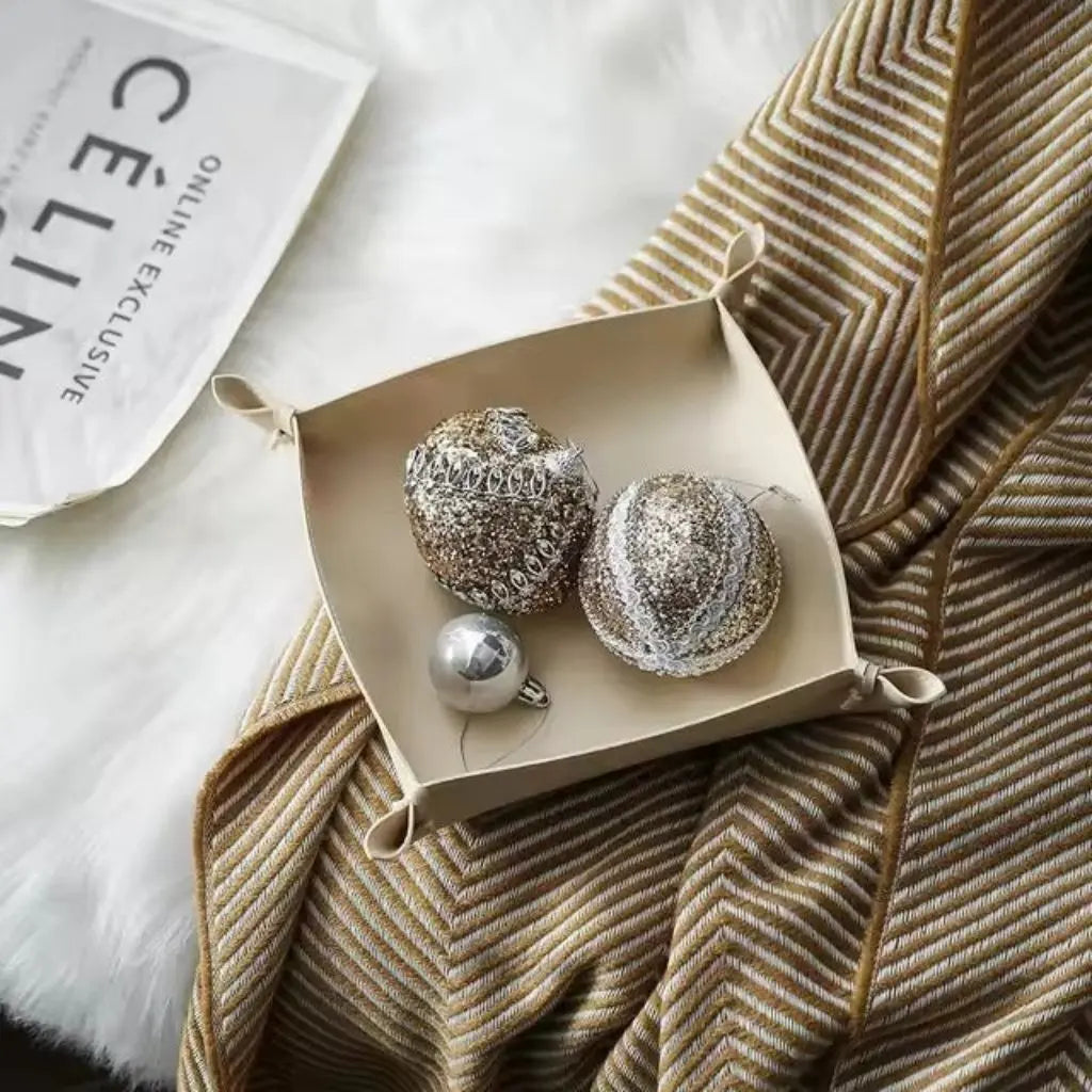 Modern leather desk organizer tray holding jewelry and accessories, perfect for bedroom dresser organization