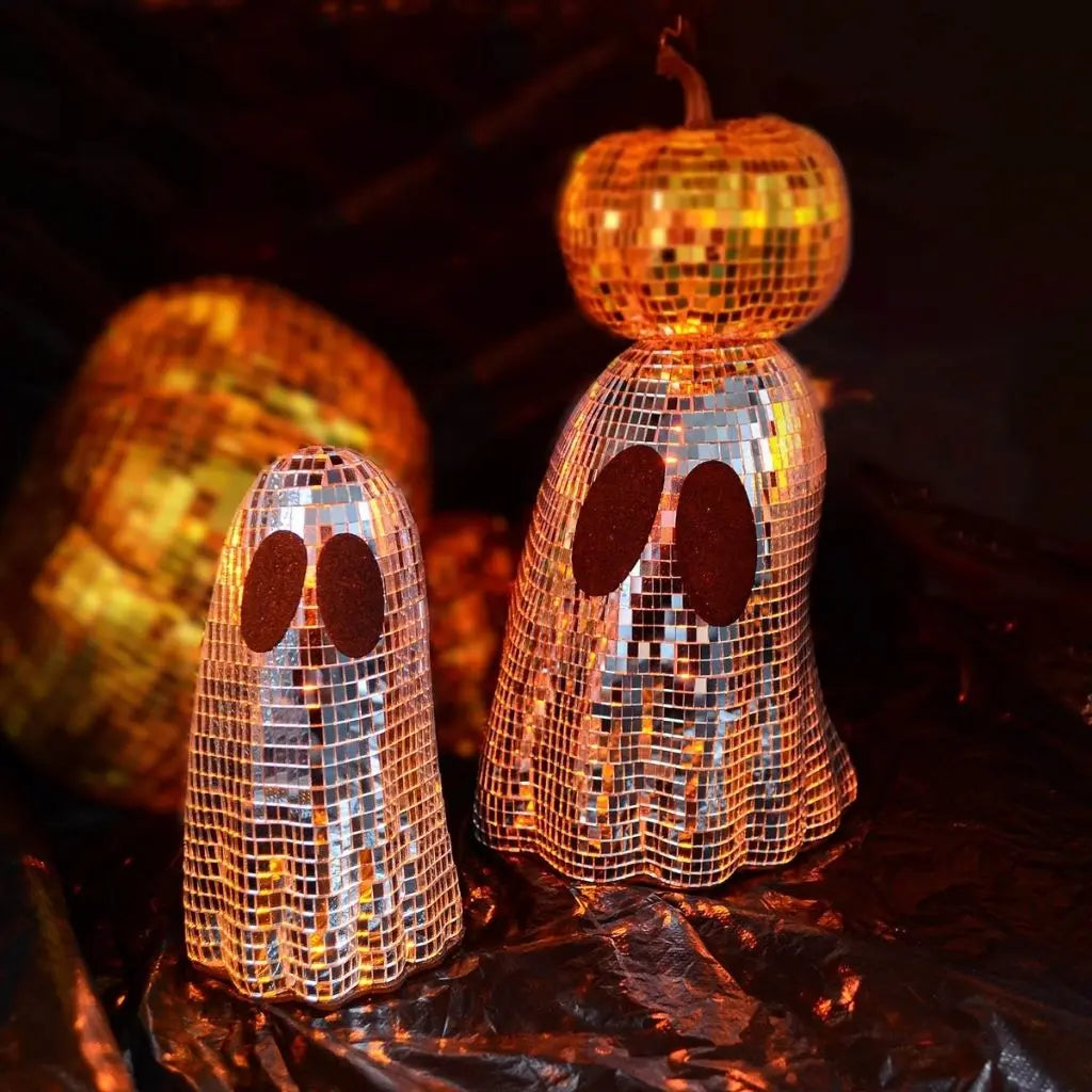 Glass mosaic ghost decoration with mirrored tiles reflecting light for Halloween tabletop display
