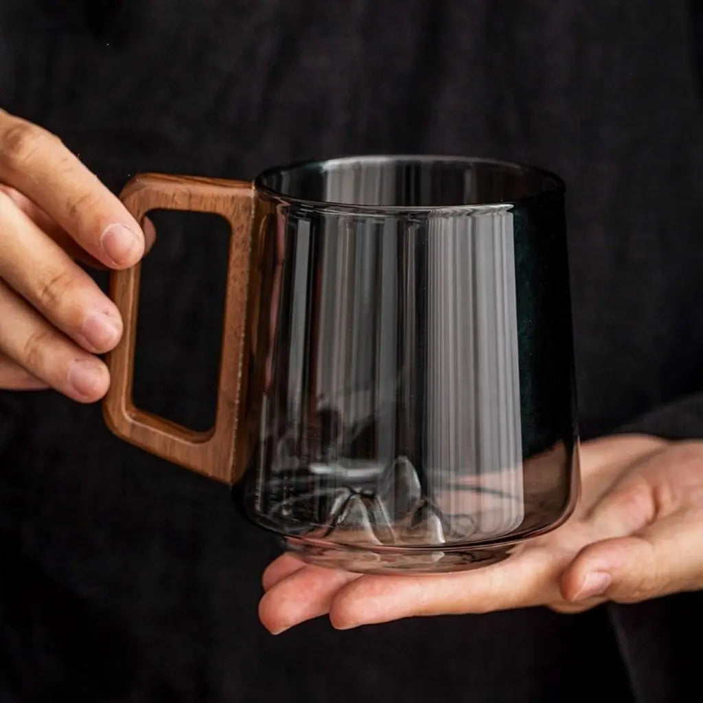 Natural wooden handle detail on borosilicate glass mug designed for comfortable grip and modern appeal